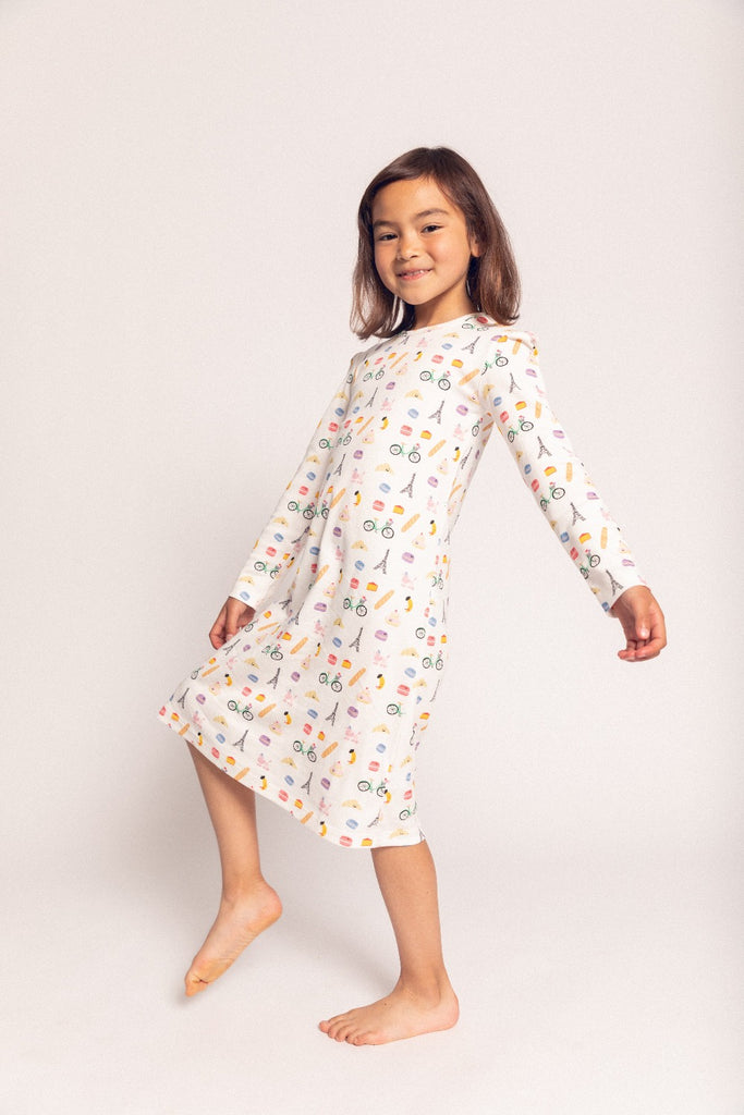 A little girl smiling while wearing a Frenchie Long Sleeve night gown from Dodo Banana